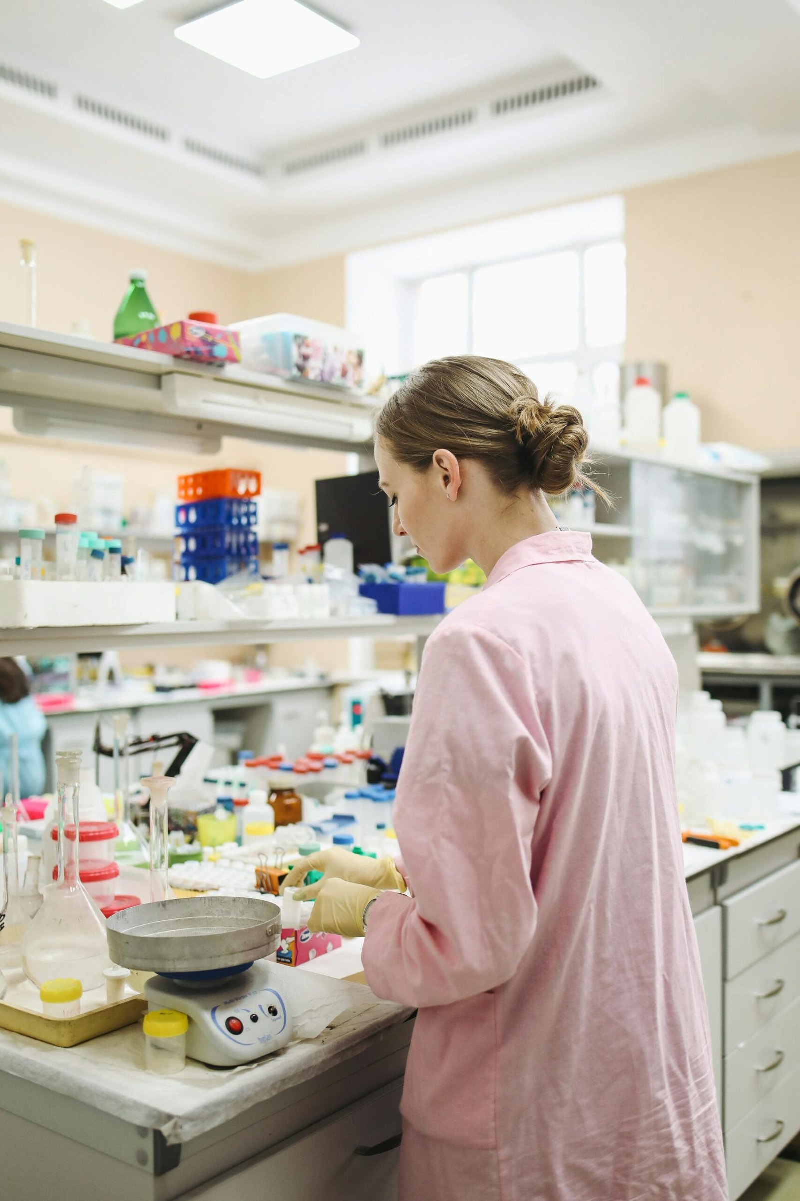 About A female scientist conducting research in a well-equipped laboratory.
